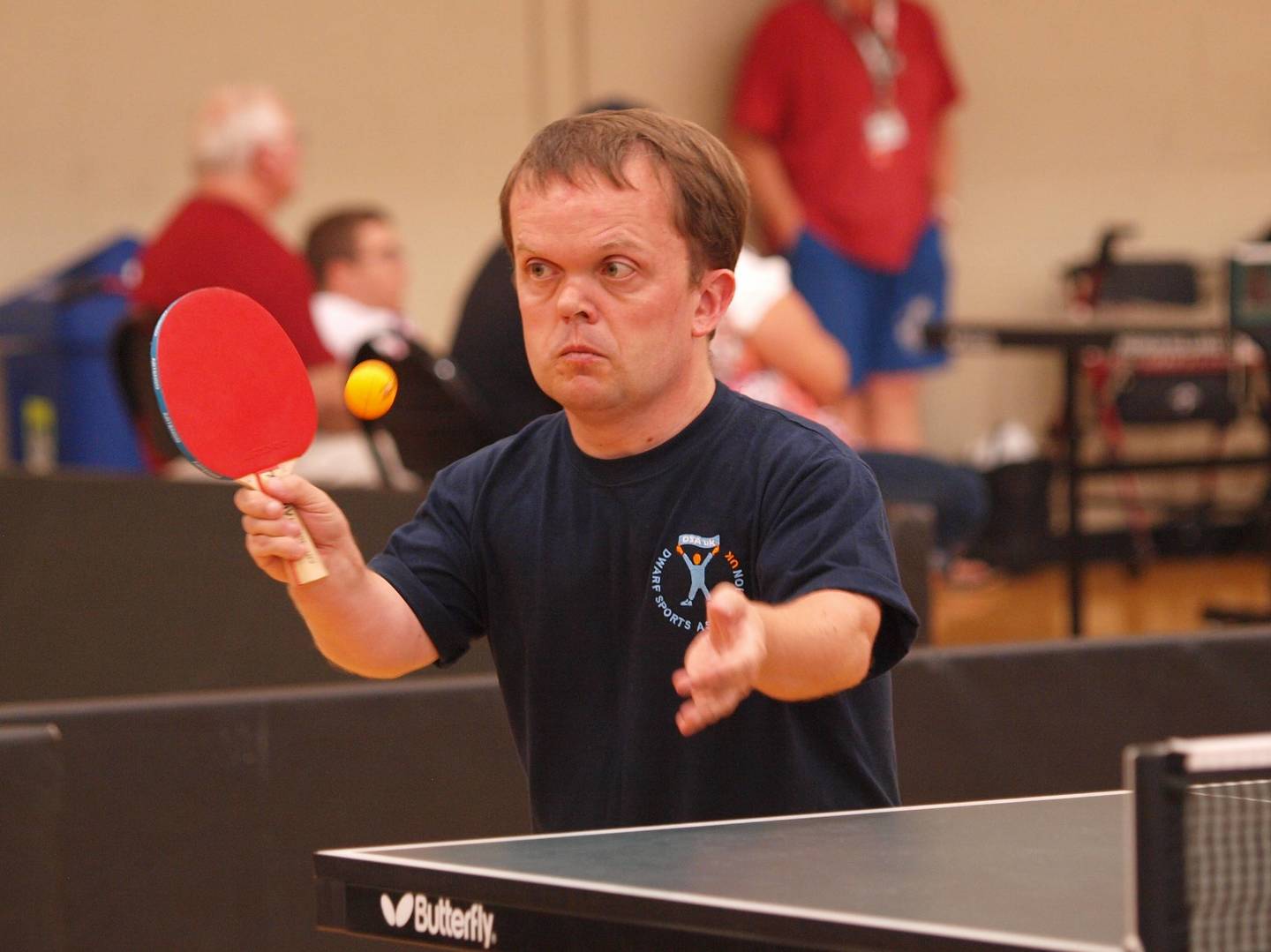 Man with dwarfism playing table tennis
