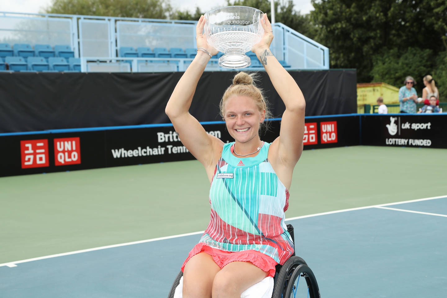 Jordanne lifting trophy at British Open Wheelchair Tennis Championships