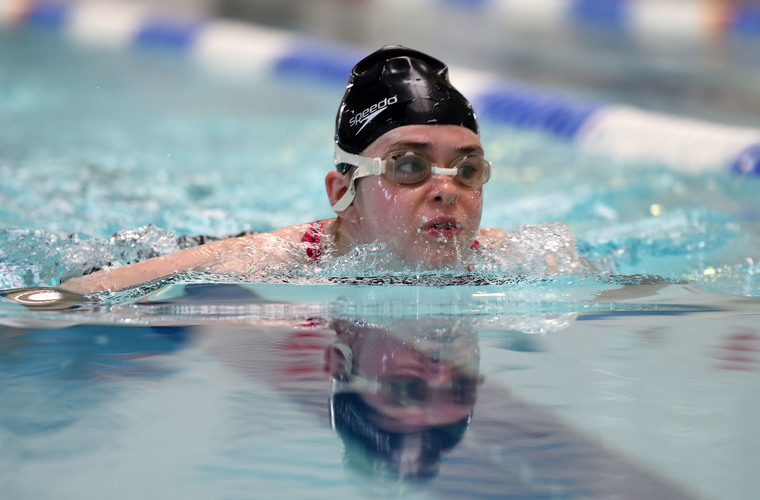 Young woman with visual impairment swimming