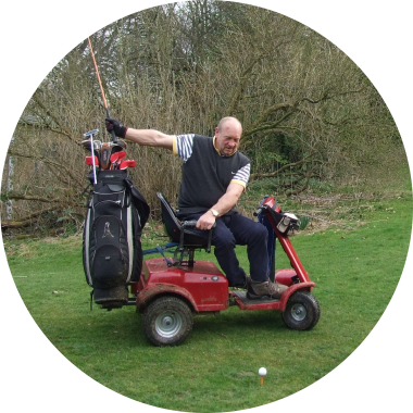 Man playing handigolf, taking shot from a seated position