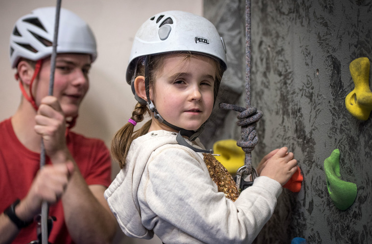 Young visually impaired girl, Ellie taking part in rock climbing. Photo credit: British Blind Sport