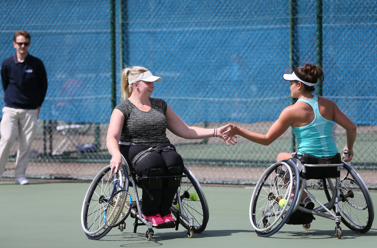 Louise and Dana playing doubles at on podium at UNIQLO Wheelchair doubles Masters UNIQLO Wheelchair Doubles Masters