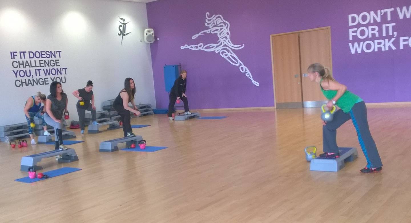 Image shows Wendy Hall leading an exercise class in dance studio.