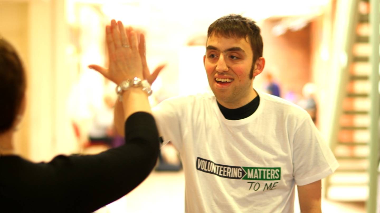 Josh, a volunteer, high fives