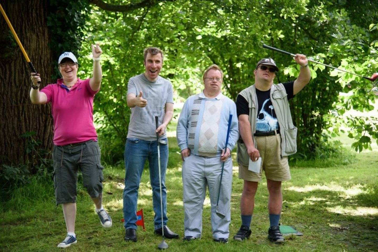Disabled adults having fun playing golf