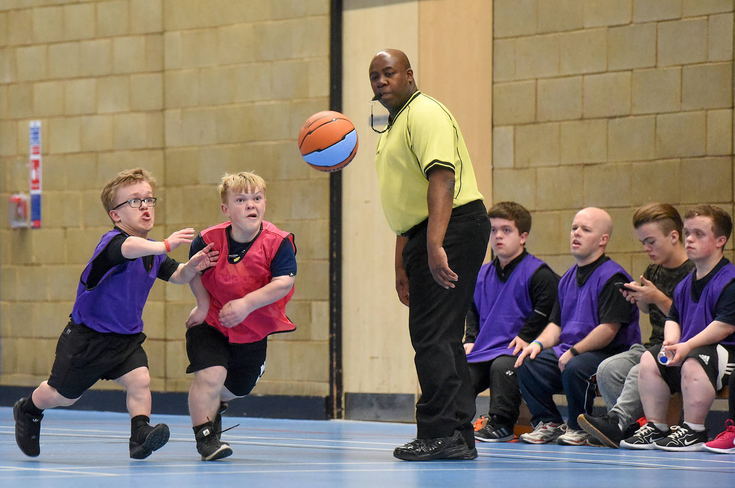 Young men with dwarfism playing basketball 