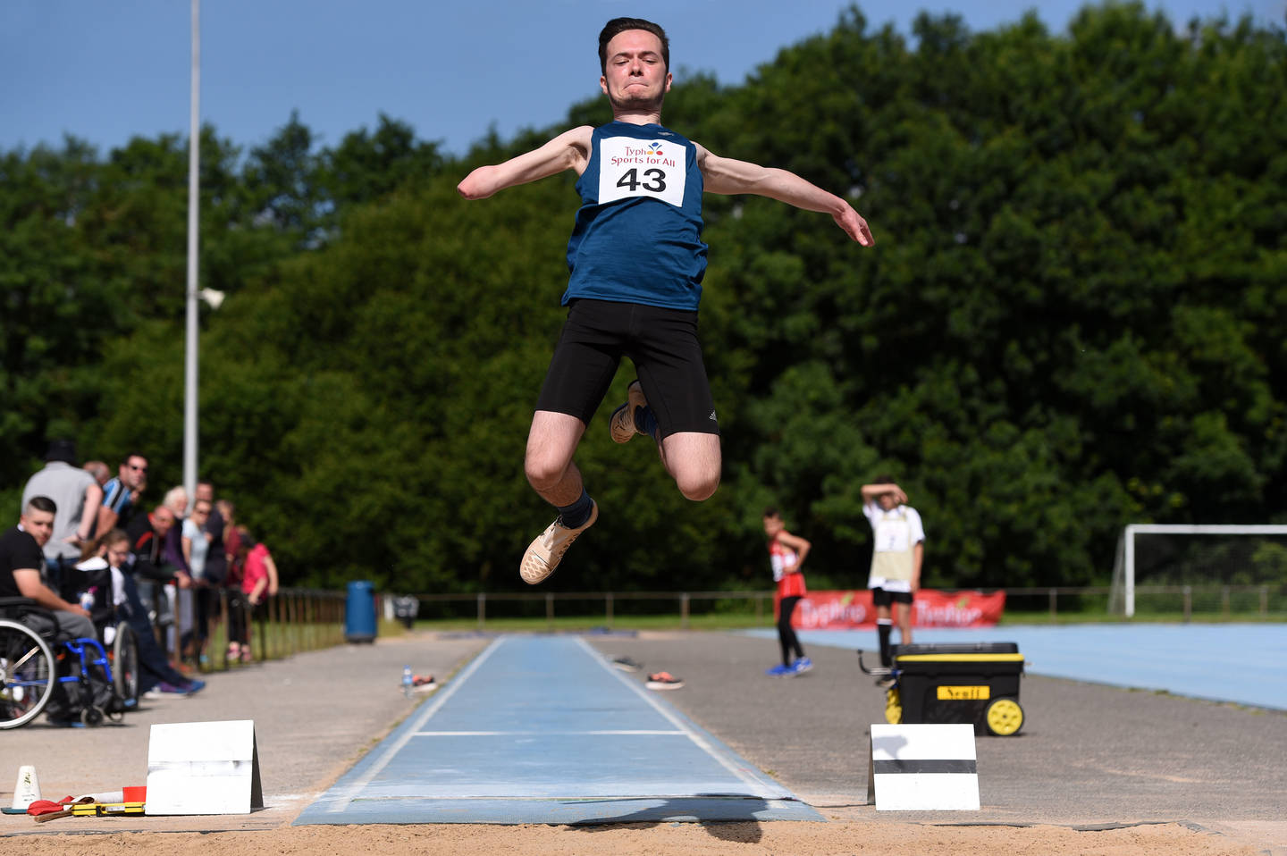 Junior athlete taking part in the long jump