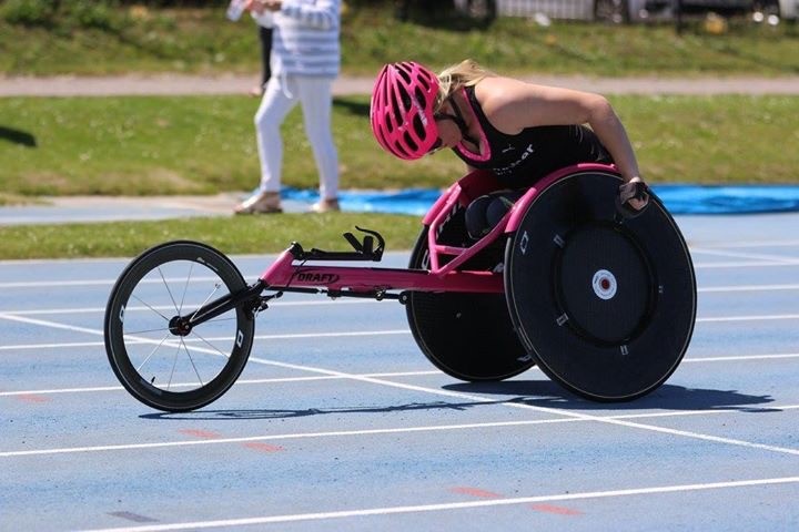 Olivia racing in her wheelchair