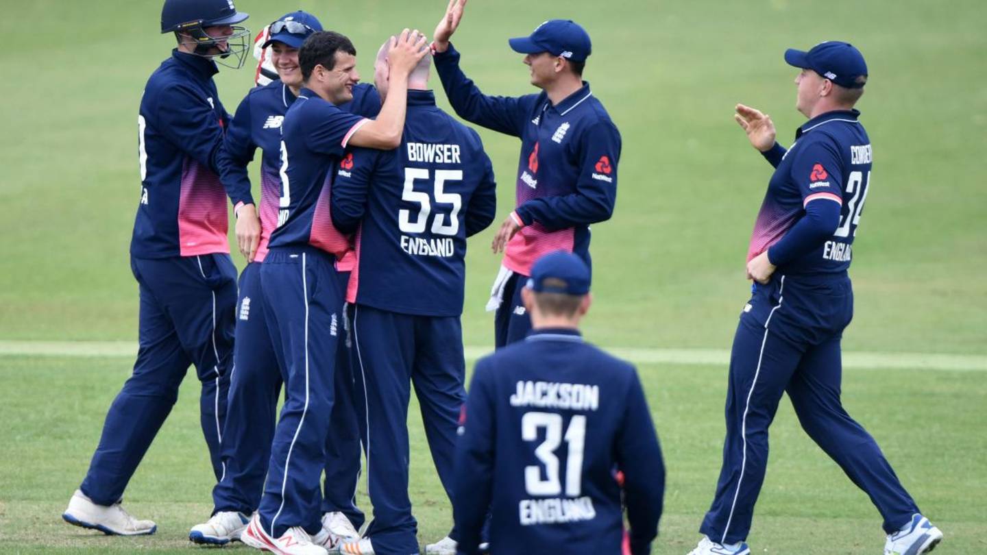 England learning disability cricket players celebrating on pitch.