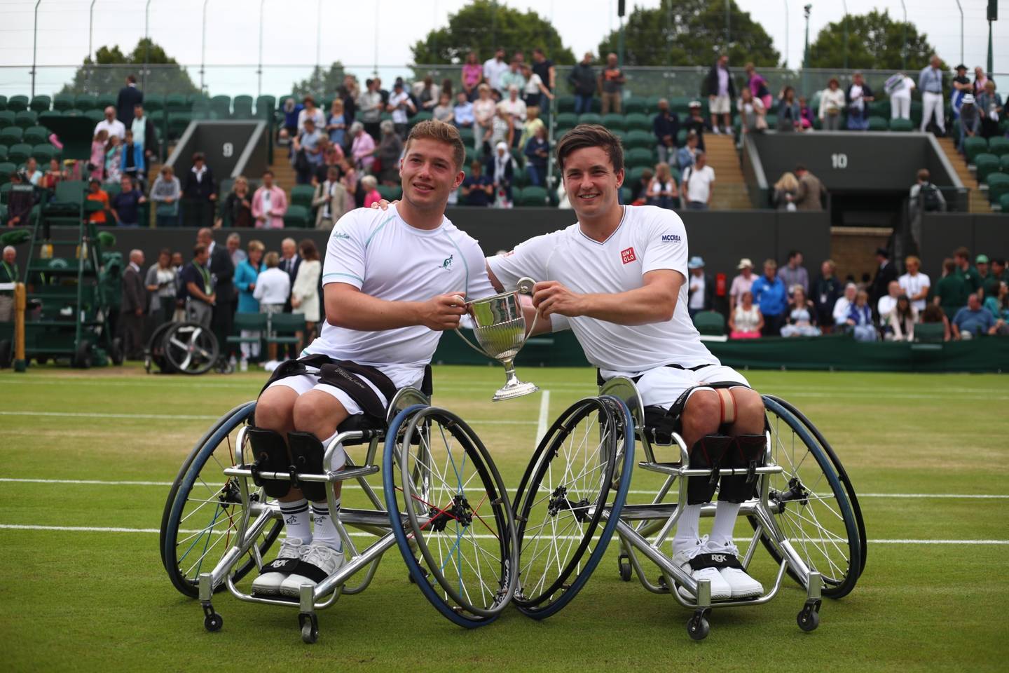 Alfie Hewett and Gordon Reid holding trophy for Wimbledon wheelchair men's doubles event