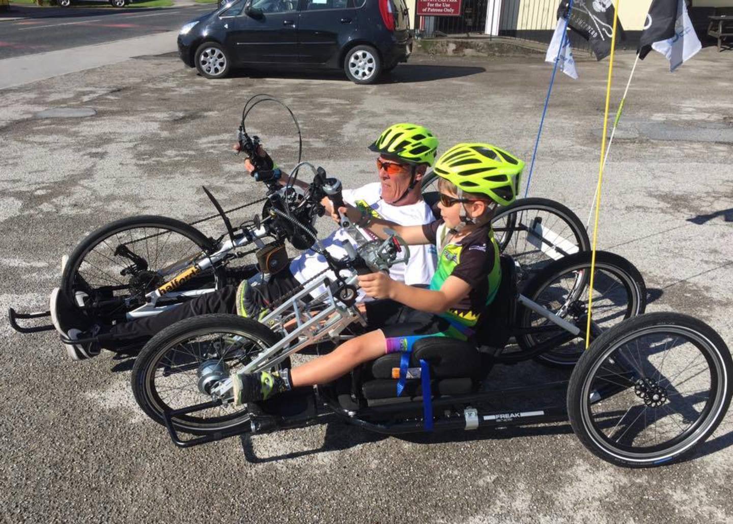 Rob and Jack handcycling during the Coastline Challenge