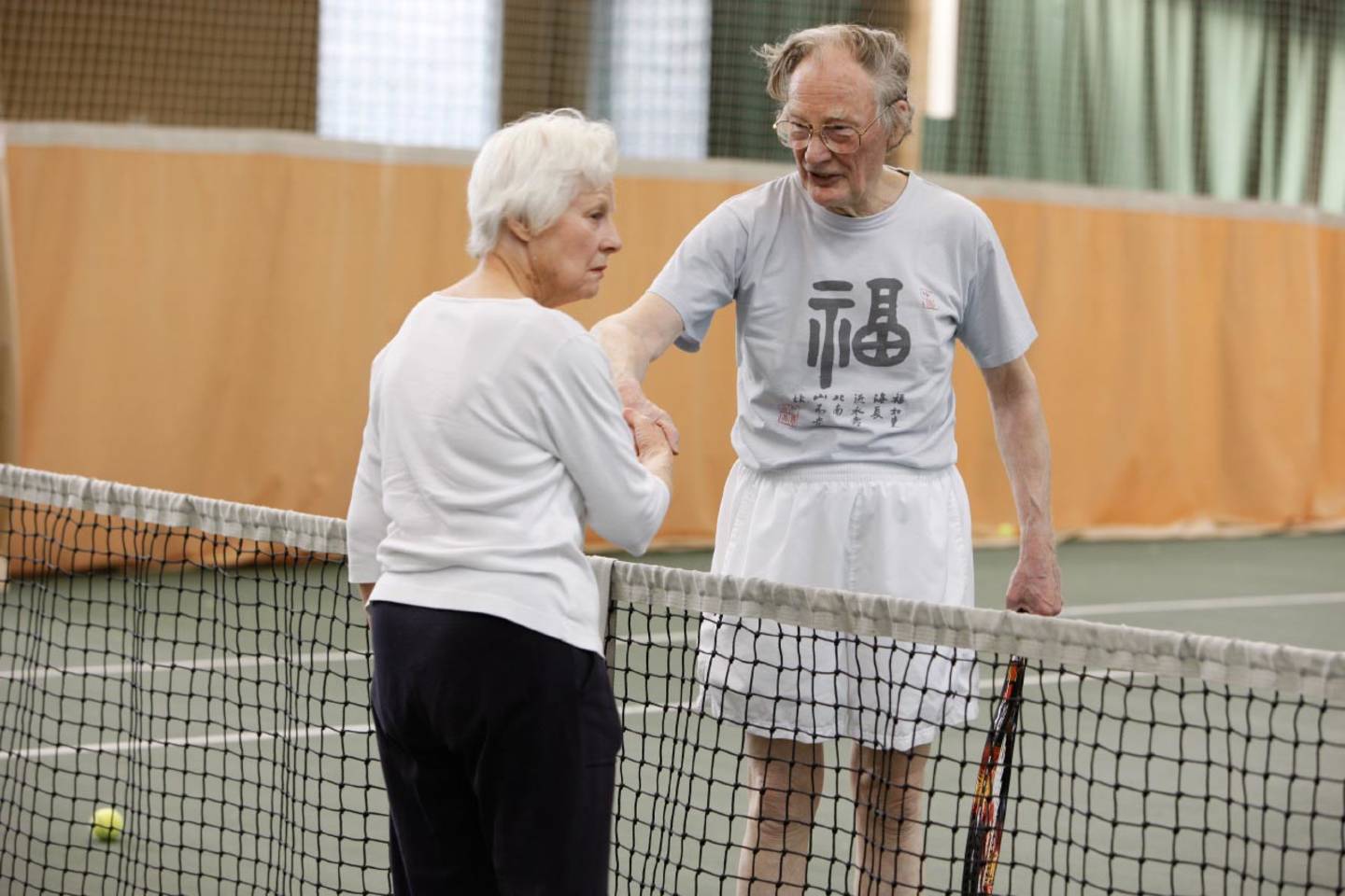 Older people playing tennis