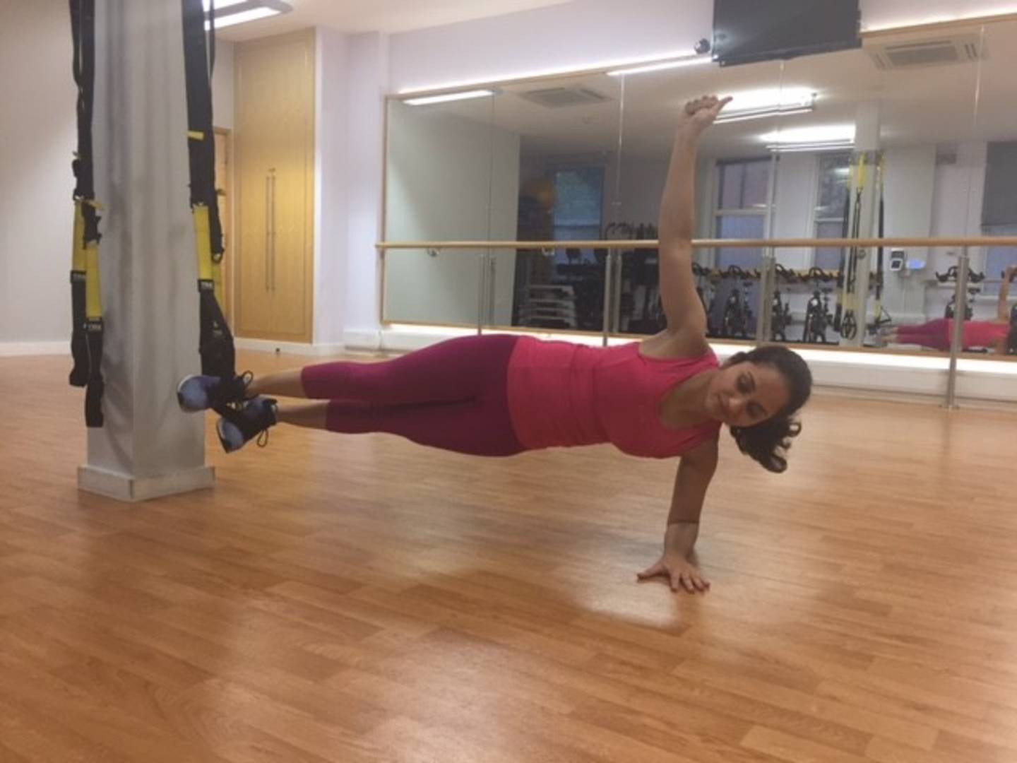 Chandni doing core exercises using TRX band in gym 