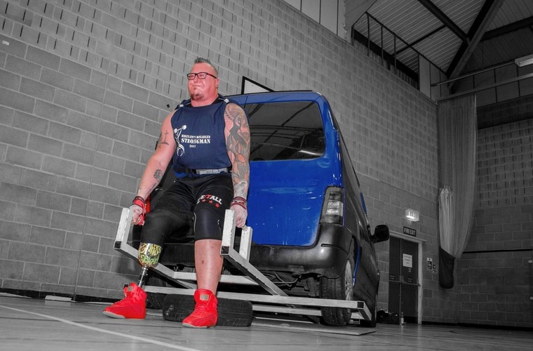 Leigh Bland lifting car in strongman competition