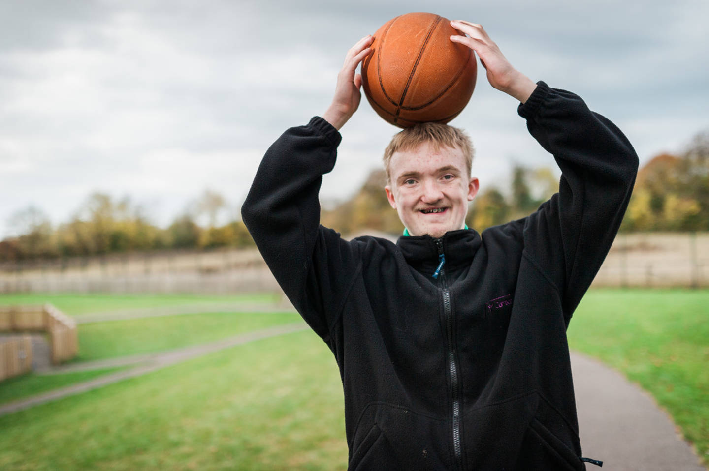 Person holding basketball - Leonard Cheshire Disability’s Can Do Sport programme aims to get 1,500 young disabled people into sport over the next three years