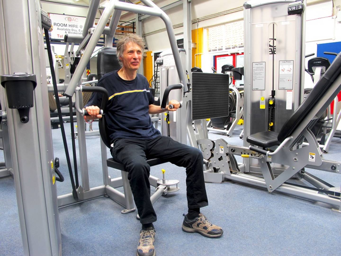 Ian Cook using chest press equipment in gym