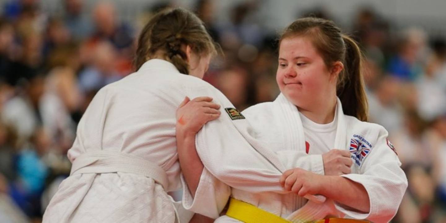 Two young women taking part in judo event