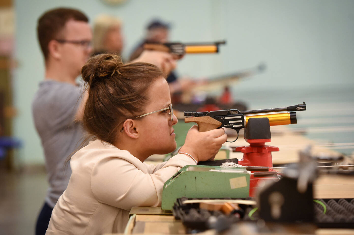 Woman with dwarfism taking part in air target shooting activity