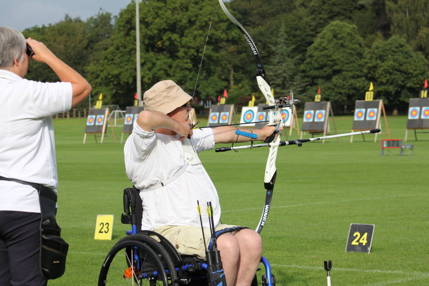 Partially sighted person taking part in archery 