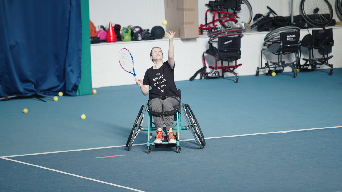 Woman ready to serve in a game of wheelchair tennis