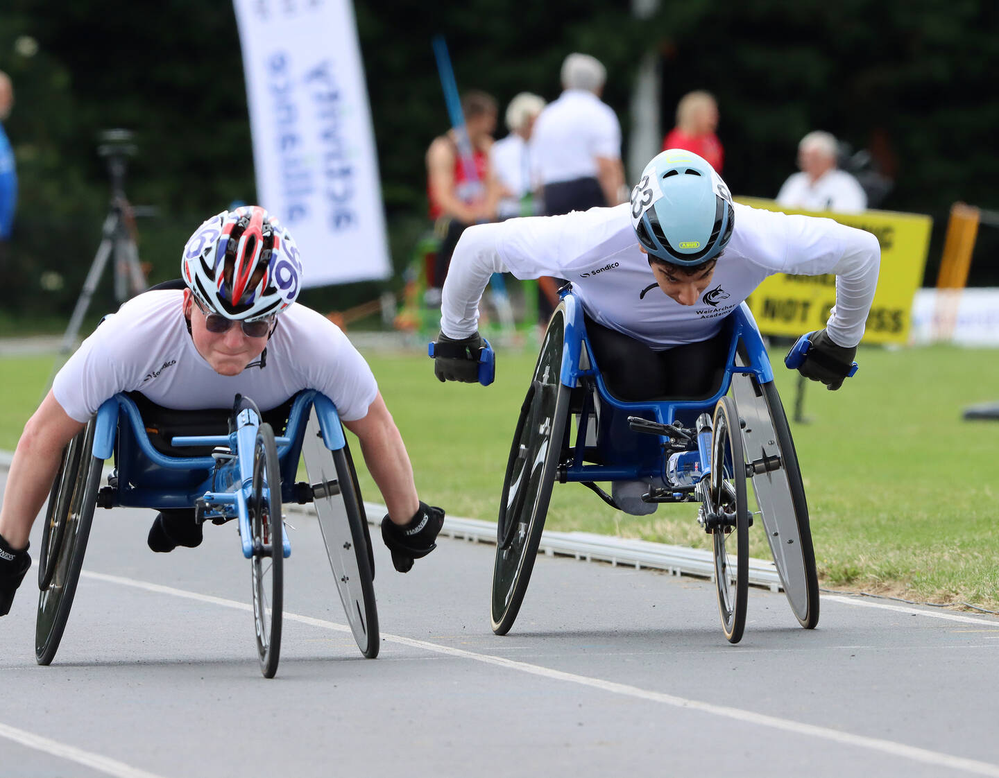 Two wheelchair athletes racing in an event at the Junior Athletics Championships